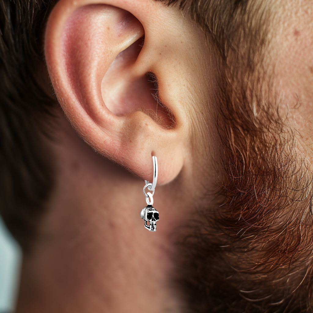 Silver hoop earring with skull